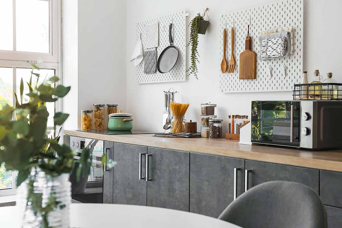 Horizontal image of assorted cooking gear and ingredients on a countertop.