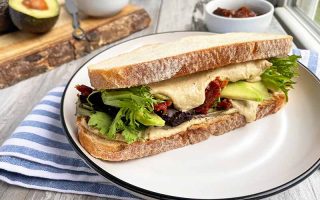 Horizontal image of a meatless sandwich on a white plate
